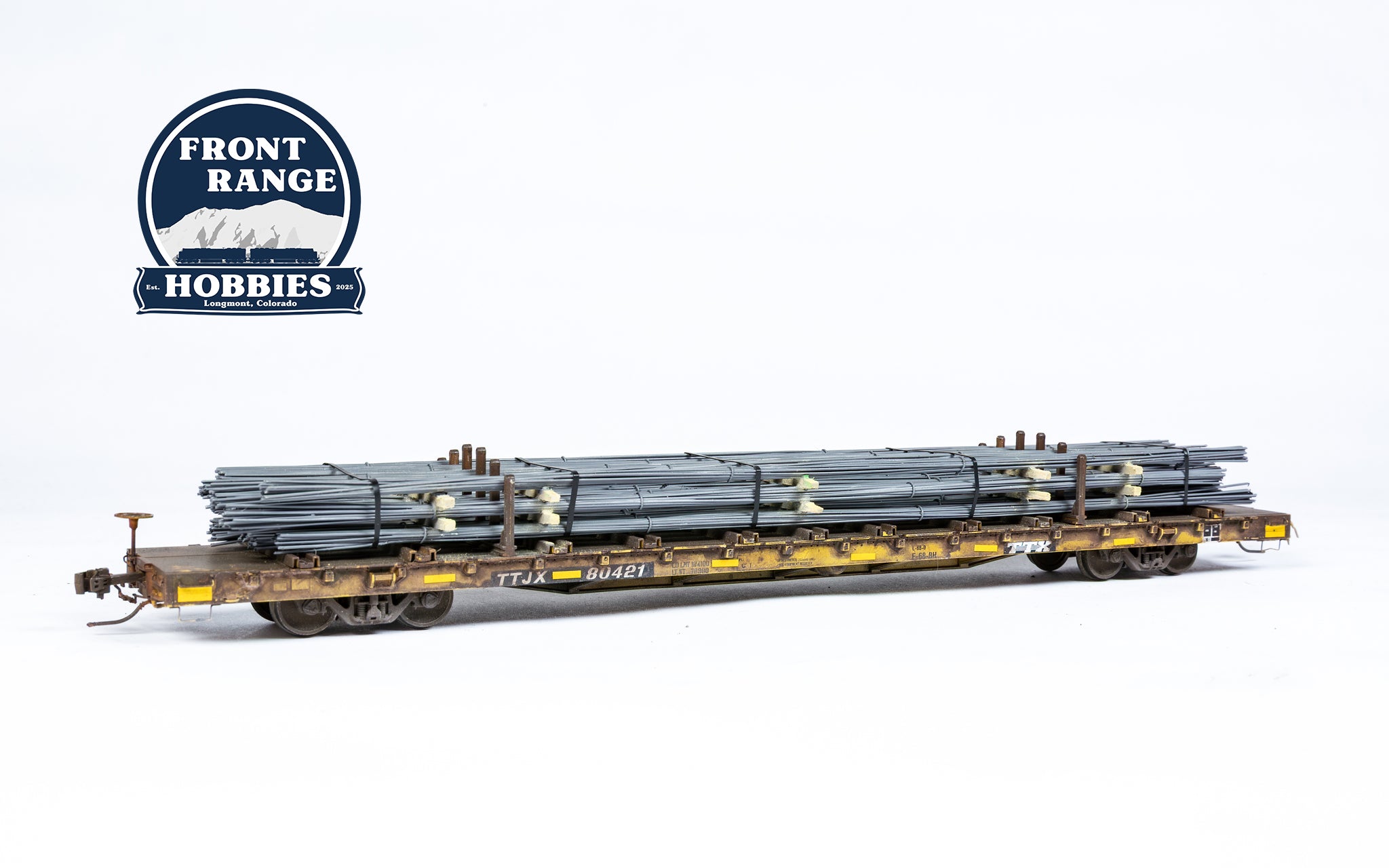 HO Scale ScaleTrains Rivet Counter BSC F68BH Finger Rack Flatcar, TTJX/1991 Speed Logo #80421 with Rebar Load